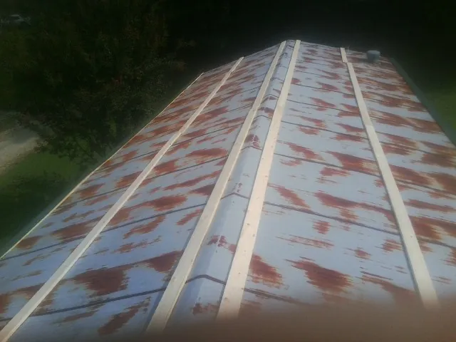 Rusted metal roof panels with new wood purlins before replacement — Storm Damage Roof Repair in Ladera Ranch by Roofing Brothers