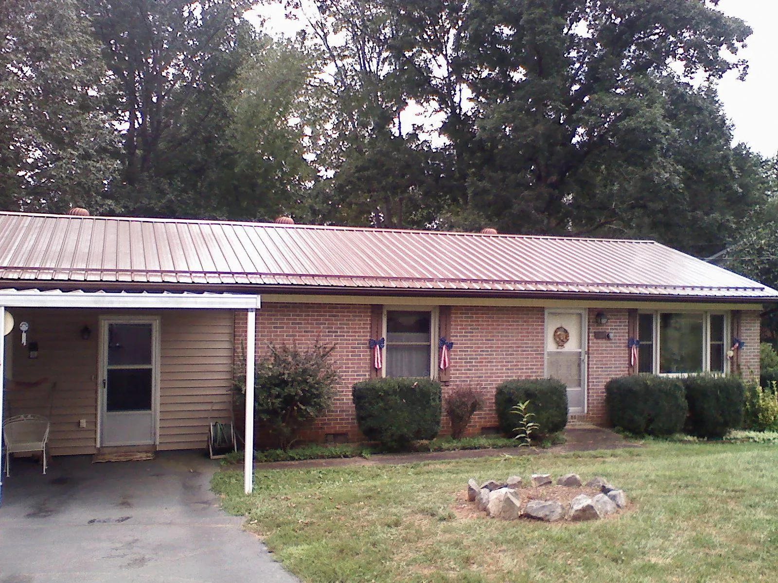 Bronze metal roof and carport on a brick ranch home — Roof Repair work by our crew in Ladera Ranch